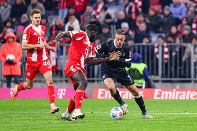 Derry Scherhant 7, SC Freiburg and Dayot Upamecano 2, FC Bayern München , in the background Josip Stanisic 44, FC Bayern München at the match between FC Bayern München v SC Freiburg, Football, Men, Bundesliga, 2025 2026, Matchday 11 on 22 11 2025 in Munich, Allianz Arena DFL and DFB regulations prohibit any use of photographs as image sequences and or quasi video Bayern Germany