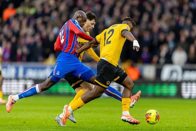 Wolverhampton Wanderers v Crystal Palace Premier League 22 11 2025. Crystal Palace forward Jean-Philippe Mateta (14) battles for possession with Wolverhampton Wanderers defender Emmanuel Agbadou (12) during the Premier League match between Wolverhampton Wanderers and Crystal Palace at Molineux, Wolverhampton, England on 22 November 2025. Editorial use only DataCo restrictions apply See www.football-dataco.com , Copyright: xManjitxNarotrax PSI-23244-0020