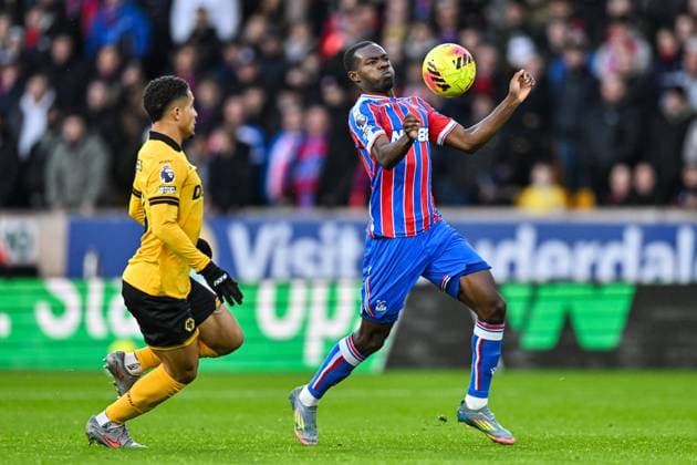 22nd November 2025; Molineux Stadium, Wolverhampton, West Midlands, England; Premier League Football, Wolverhampton Wanderers versus Crystal Palace; Tyrick Mitchell of Crystal Palace controls the ball on his chest under pressure from Joao Gomes of Wolverhampton Wanderers  GodfreyxPitt