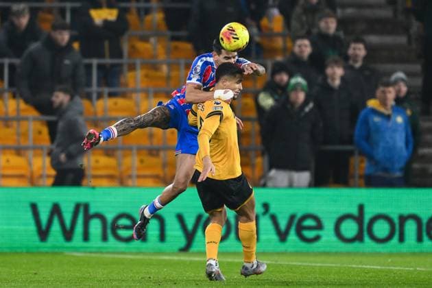 Wolverhampton, England, 22nd November 2025. Daniel Munoz of Crystal Palace wins the high ball over Joao Gomes of Wolverhampton Wanderers during the Wolverhampton Wanderers vs Crystal Palace Premier League match at Molineux, Wolverhampton. Picture credit should read: Craig Thomas Sportimage EDITORIAL USE ONLY. No use with unauthorised audio, video, data, fixture lists, club league logos or live services. Online in-match use limited to 120 images, no video emulation. No use in betting, games or single club league player publications. SPI-4302_WOLVES_V_CRYSTAL_PALACE-097 SPI-4302-0097