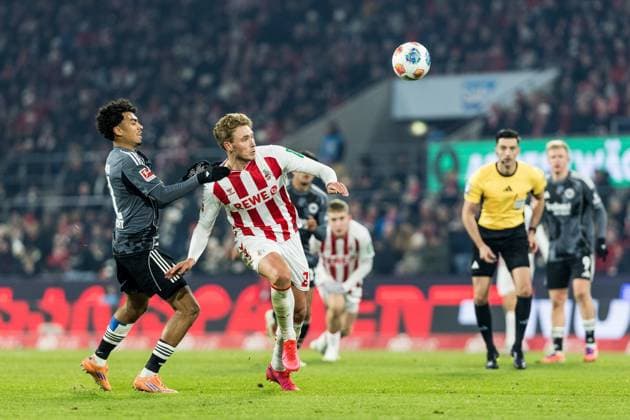 KOELN, GERMANY - NOVEMBER 25: Nathaniel Brown (Eintracht Frankfurt, 21) and Sebastian Sebulonsen (1. FC Koeln, 28) battle for the ball during the Bundesliga match between 1. FC Koeln vs. Eintracht Frankfurt at Rheinenergie-Stadion on matchday 11 of the 1. Bundesliga on November 22, 2025 in Koeln, Germany. DFL REGULATIONS PROHIBIT ANY USE OF PHOTOGRAPHS AS IMAGE SEQUENCES AND OR QUASI-VIDEO. North Rhine Westphalia Germany Copyright: xBEAUTIFULxSPORTS Wunderlx