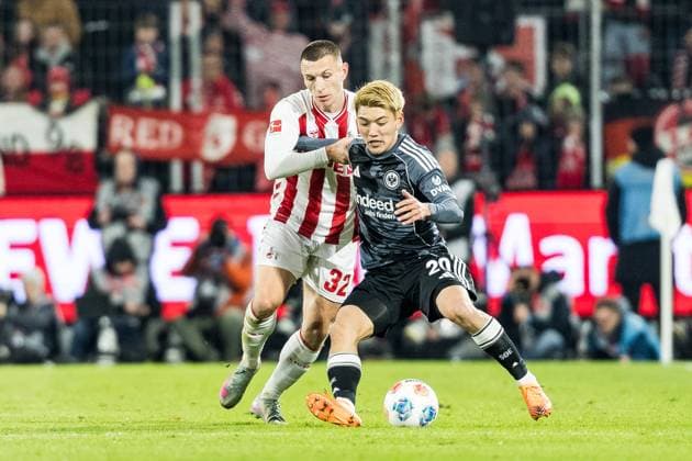 KOELN, GERMANY - NOVEMBER 25: Kristoffer Lund (1. FC Koeln, 32) and Ritsu Doan (Eintracht Frankfurt, 20) fight for the ball during the Bundesliga match between 1. FC Koeln vs. Eintracht Frankfurt at Rheinenergie-Stadion on matchday 11 of the 1. Bundesliga on November 22, 2025 in Koeln, Germany. DFL REGULATIONS PROHIBIT ANY USE OF PHOTOGRAPHS AS IMAGE SEQUENCES AND OR QUASI-VIDEO. North Rhine Westphalia Germany Copyright: xBEAUTIFULxSPORTS Wunderlx