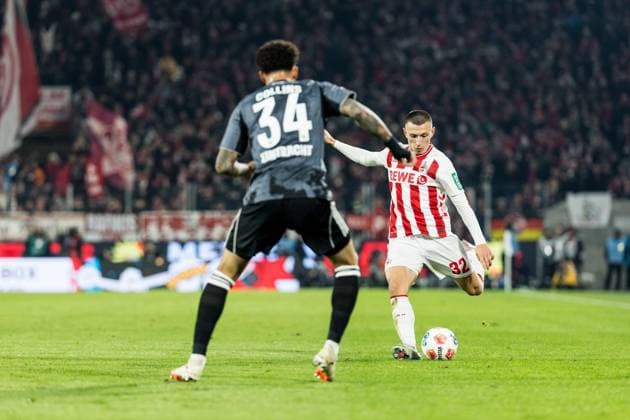 KOELN, GERMANY - NOVEMBER 25: Nnamdi Collins (Eintracht Frankfurt, 34) and Kristoffer Lund (1. FC Koeln, 32) battle for the ball during the Bundesliga match between 1. FC Koeln vs. Eintracht Frankfurt at Rheinenergie-Stadion on matchday 11 of the 1. Bundesliga on November 22, 2025 in Koeln, Germany. DFL REGULATIONS PROHIBIT ANY USE OF PHOTOGRAPHS AS IMAGE SEQUENCES AND OR QUASI-VIDEO. North Rhine Westphalia Germany Copyright: xBEAUTIFULxSPORTS Wunderlx