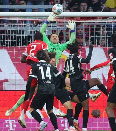 (251123) -- MUNICH, Nov. 23, 2025 -- Bayern Munich s goalkeeper Manuel Neuer (rear) makes a save during the German first division Bundesliga football match between Bayern Munich and SC Freiburg in Munich, Germany, Nov. 22, 2025. (Photo by Xinhua) (SP)GERMANY-MUNICH-FOOTBALL-BUNDESLIGA-BAYERN MUNICH VS FREIBURG PhilippexRuiz 
