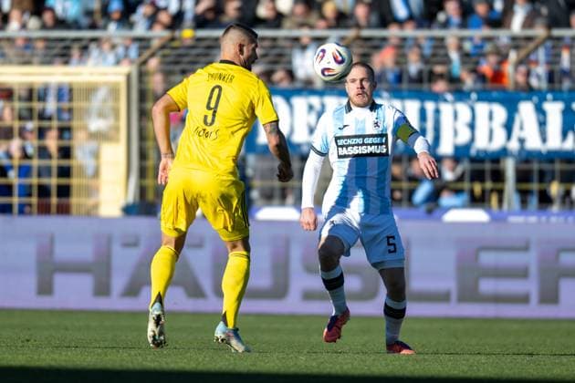 Thore Jacobson 5 TSV 1860 Muenchen in duel with Kai Bruenker 9 1 FC Saarbruecken , TSV 1860 Muenchen vs 1 FC Saarbruecken, 3 Liga, 15 Spieltag, 23 11 2025 DFB regulations prohibit any use of photographs as image sequences and or quasi video Muenchen Bayern Germany Copyright: xkolbert-press UlrichxGamelx