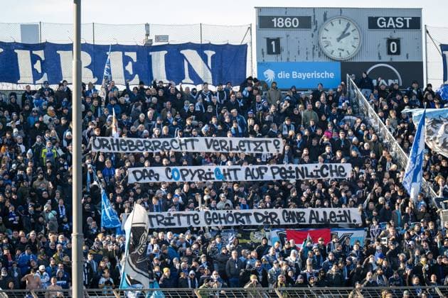 Fans with the banner Copyright É, TSV 1860 Muenchen vs 1 FC Saarbruecken, 3 Liga, 15 Spieltag, 23 11 2025 DFB regulations prohibit any use of photographs as image sequences and or quasi video Muenchen Bayern Germany Copyright: xkolbert-press UlrichxGamelx
