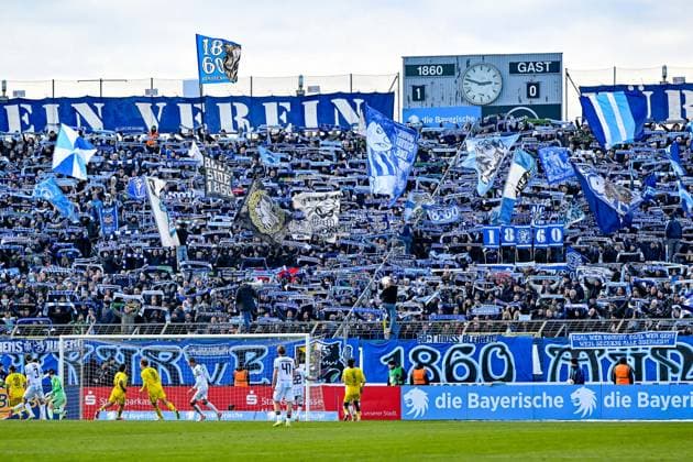 Fans of TSV 1860 Muenchen show their scarves, wave flags and make atmosphere, fans, audience, spectators, mood, atmosphere, stadium, 23 11 2025, Munich Germany , football, 3 Liga, TSV 1860 München 1 FC Saarbrücken, DFB DFL REGULATIONS PROHIBIT ANY USE OF PHOTOGRAPHS AS IMAGE SEQUENCES AND OR QUASI VIDEO xslx