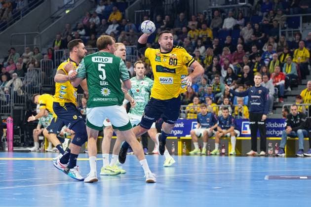 Jannik Kohlbacher 80 Rhein Neckar Löwen throws the ball while Dani Baijens 77 Rhein Neckar Löwen , Matthes Langhoff 13 Füchse Berlin and Max Darj 5 Füchse Berlin defend 1 Handball Bundesliga Rhein Neckar Löwen vs Füchse Berlin 23 11 2025 Copyright: xSpeedshotx