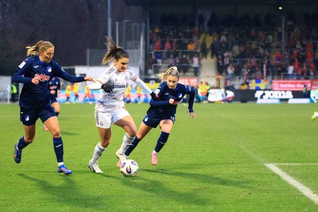 Jovana Damnjanovic 9 FC Bayern Munich with ball, while Janna Grimm 26 TSG Hoffenheim Women and another player of TSG Hoffenheim Women defend player with ball pressured Copyright: xspeedshotx