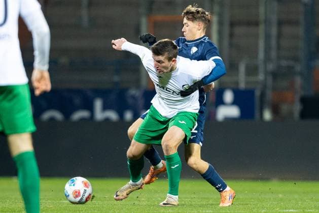 23 11 2025, xkwix, Football, Regionalliga West, VfL Bochum 1848 U21 FC Gütersloh, Vonovia Ruhrstadion Kacper Koscierski VfL Bochum U21 2 in duel against Aleksandar Kandic FC Gütersloh 27 NRW Germany