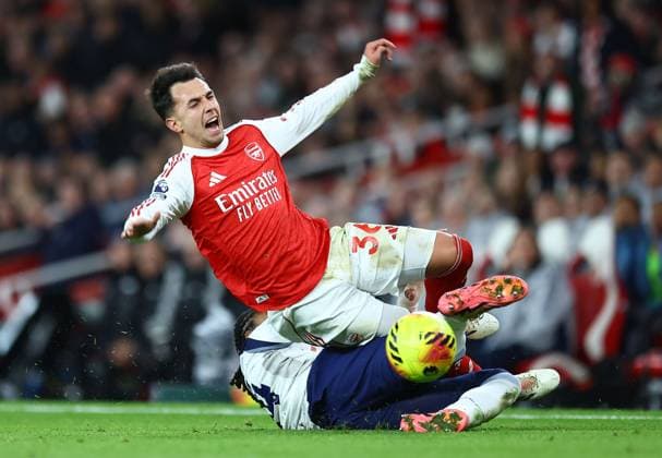 Martin Zubimendi of Arsenal is fouled by Djed Spence of Tottenham Hotspur Arsenal v Tottenham Hotspur, Premier League, Football, Emirates Stadium, London, UK - 23 Nov 2025London Emirates Stadium United Kingdom EDITORIAL USE ONLY No use with unauthorised audio, video, data, fixture lists, club league logos or live services. Online in-match use limited to 120 images, no video emulation. No use in betting, games or single club league player publications.  Copyright: xMichaelxZemanek Shutterstockx 15860967aw