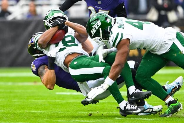 New York Jets wide receiver Isaiah Williams (18) is stopped by the Baltimore Ravens defense after a punt return during the first quarter at M&T Bank Stadium in Baltimore, Maryland, on Sunday, November 23, 2025.  BAL20251123109 DAVIDxTULIS