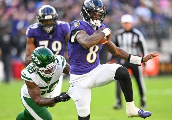 Baltimore Ravens quarterback Lamar Jackson (8) scrambles for a 2 yard gain against New York Jets defensive lineman Mazi Smith (58) during the fourth quarter at M&T Bank Stadium in Baltimore, Maryland, on Sunday, November 23, 2025. Baltimore won 23-10.  BAL20251123134 DAVIDxTULIS