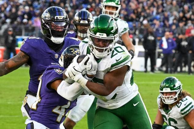 New York Jets running back Breece Hall (20) runs toward the goal line under pressure from Baltimore Ravens cornerback Marlon Humphrey (44) who forced a fumble on the 3 yard line for a turnover during the fourth quarter at M&T Bank Stadium in Baltimore, Maryland, on Sunday, November 23, 2025. Baltimore won 23-10.  BAL20251123144 DAVIDxTULIS