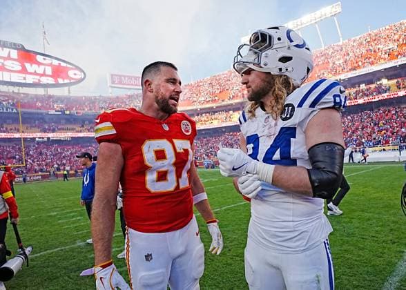Kansas City Chiefs tight end Travis Kelce (87) talks post game with Indianapolis Colts tight end Tyler Warren (84) at Arrowhead Stadium in Kansas City, Missouri on Sunday, November 23, 2025.  KCP2025112304 JONxROBICHAUD