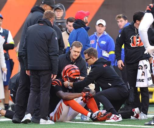 Cincinnati Bengals wide receiver Tee Higgins (5) is checked out by Bengals medical staff on the field after taking a hard hit by New England Patriots Carlton Davis (7) during the second half of play at Paycor Stadium on Sunday, November 23, 2025 in Cincinnati, Ohio.  KYP20251123036 JOHNxSOMMERSxII
