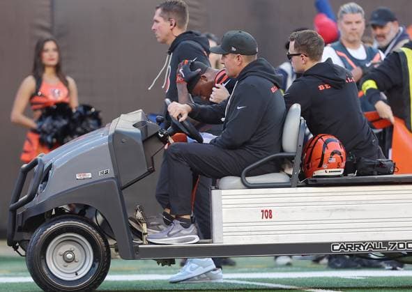 Cincinnati Bengals wide receiver Tee Higgins (5) taken off the field by Bengals medical staff on the field after taking a hard hit by New England Patriots Carlton Davis (7) during the second half of play at Paycor Stadium on Sunday, November 23, 2025 in Cincinnati, Ohio.  KYP20251123037 JOHNxSOMMERSxII