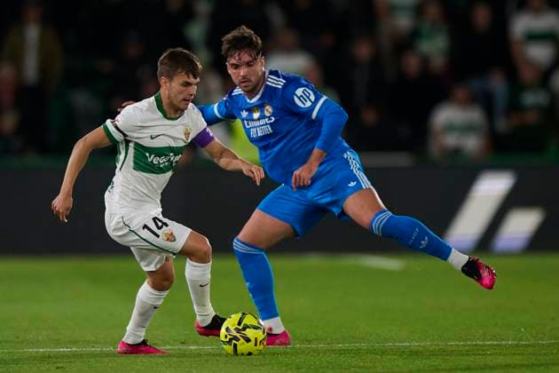 (251124) -- ELCHE, Nov. 24, 2025 -- Raul Asencio (R) of Real Madrid vies with Aleix Febas of Elche during the La Liga football match between Elche and Real Madrid in Elche, Spain, on Nov. 23, 2025. (SP)SPAIN-ELCHE-FOOTBALL-LA LIGA-ELCHE VS REAL MADRID PABLOxMORANO 