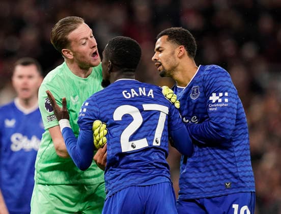 Manchester, England, 24th November 2025. Jordan Pickford of Everton (l) and Iliman Ndiaye of Everton (r) holds back red carded Idrissa Gueye of Everton following a clash with Michael Keane of Everton during the Manchester United, ManU vs Everton Premier League match at Old Trafford, Manchester. Picture credit should read: Andrew Yates Sportimage EDITORIAL USE ONLY. No use with unauthorised audio, video, data, fixture lists, club league logos or live services. Online in-match use limited to 120 images, no video emulation. No use in betting, games or single club league player publications. SPI_038_AY_Manchester_Utd_Everton SPI-4308-0037