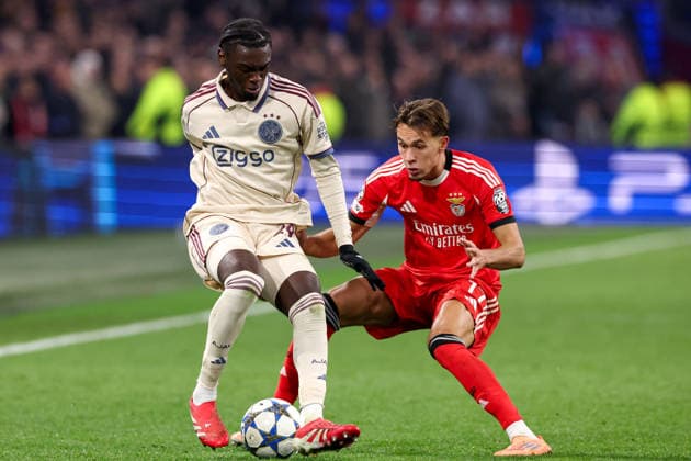 2025-11-25 AFC Ajax v SL Benfica - UEFA Champions League 2025 26 League Phase MD5 AMSTERDAM, NETHERLANDS - NOVEMBER 25: Jorthy Mokio of AFC Ajax battles for possession with Amar Dedic of SL Benfica during the UEFA Champions League 2025 26 League Phase MD5 match between AFC Ajax and SL Benfica at Johan Cruyff Arena on November 25, 2025 in Amsterdam, Netherlands. Amsterdam Johan Cruyff Arena Netherlands Content not available for redistribution in The Netherlands directly or indirectly through any third parties. Copyright: xBenxGalx
