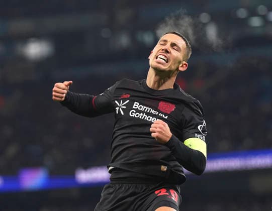 Manchester, England, 25th November 2025. Alex Grimaldo of Bayer Leverkusen celebrates scoring the first goal during the Manchester City vs Bayer Leverkusen UEFA Champions League match at the Etihad Stadium, Manchester. Picture credit should read: Andrew Yates Sportimage EDITORIAL USE ONLY. No use with unauthorised audio, video, data, fixture lists, club league logos or live services. Online in-match use limited to 120 images, no video emulation. No use in betting, games or single club league player publications. SPI_033_AY_Man_City_Leverkusen SPI-4309-0047