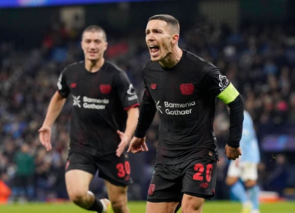 Manchester, England, 25th November 2025. Alex Grimaldo of Bayer Leverkusen celebrates scoring the first goal during the Manchester City vs Bayer Leverkusen UEFA Champions League match at the Etihad Stadium, Manchester. Picture credit should read: Andrew Yates Sportimage EDITORIAL USE ONLY. No use with unauthorised audio, video, data, fixture lists, club league logos or live services. Online in-match use limited to 120 images, no video emulation. No use in betting, games or single club league player publications. SPI_044_AY_Man_City_Leverkusen SPI-4309-0058