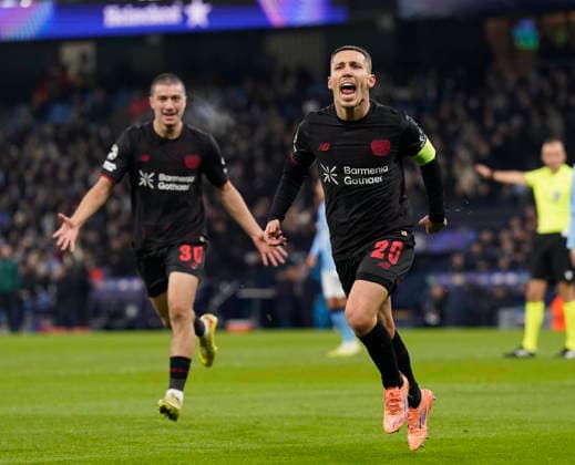 Manchester, England, 25th November 2025. Alex Grimaldo of Bayer Leverkusen celebrates scoring the first goal during the Manchester City vs Bayer Leverkusen UEFA Champions League match at the Etihad Stadium, Manchester. Picture credit should read: Andrew Yates Sportimage EDITORIAL USE ONLY. No use with unauthorised audio, video, data, fixture lists, club league logos or live services. Online in-match use limited to 120 images, no video emulation. No use in betting, games or single club league player publications. SPI_046_AY_Man_City_Leverkusen SPI-4309-0060