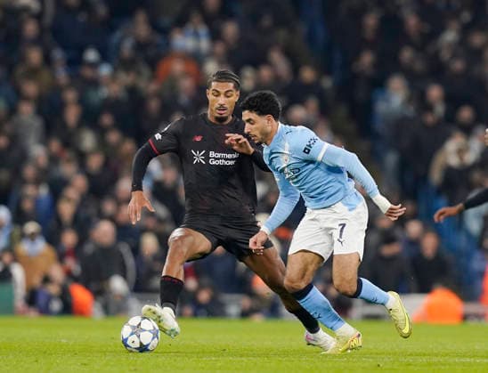 Manchester, England, 25th November 2025. Loic Bade of Bayer Leverkusen (l) and Omar Marmoush of Manchester City (r) during the Manchester City vs Bayer Leverkusen UEFA Champions League match at the Etihad Stadium, Manchester. Picture credit should read: Andrew Yates Sportimage EDITORIAL USE ONLY. No use with unauthorised audio, video, data, fixture lists, club league logos or live services. Online in-match use limited to 120 images, no video emulation. No use in betting, games or single club league player publications. SPI_047_AY_Man_City_Leverkusen SPI-4309-0061
