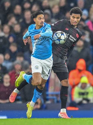 Manchester City v Bayer Leverkusen UEFA Champions League Tijjani Reijnders of Manchester City Malik Tillman of Bayer Leverkusen battles for the ball during the UEFA Champions League match at the Etihad Stadium, Manchester UK Newspapers OUT Copyright: xKarlxVallantinex FIL-22550-0025