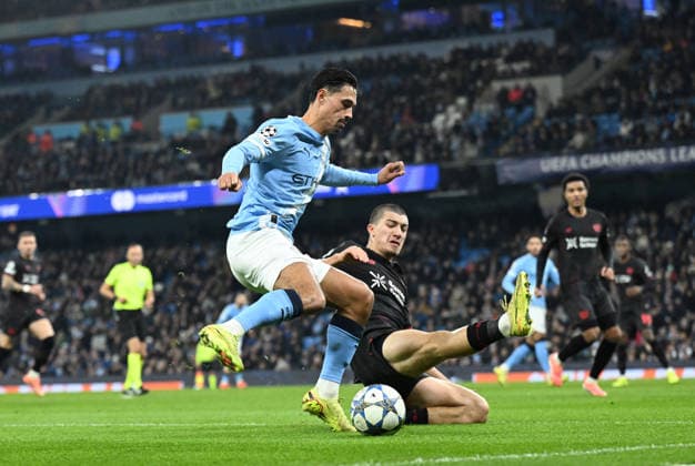 Manchester, England, 25th November 2025. Tijjani Reijnders of Manchester City tackled by Ibrahim Maza of Bayer Leverkusen during the Manchester City vs Bayer Leverkusen UEFA Champions League match at the Etihad Stadium, Manchester. Picture credit should read: Cody Froggatt Sportimage EDITORIAL USE ONLY. No use with unauthorised audio, video, data, fixture lists, club league logos or live services. Online in-match use limited to 120 images, no video emulation. No use in betting, games or single club league player publications. SPI_018_CF_Man_City_Bayer SPI-4309-0066