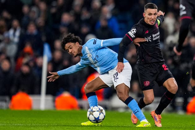 MANCHESTER, ENGLAND - NOVEMBER 25: Oscar Bobb of Manchester City and Alejandro Grimaldo of Bayer 04 Leverkusen battle for the ball during the UEFA Champions League 2025 26 League Phase MD5 match between Manchester City and Bayer 04 Leverkusen at City of Manchester Stadium on November 25, 2025 in Manchester, England. (Photo by Rene Nijhuis) SPO  Copyright: xRenexNijhuis