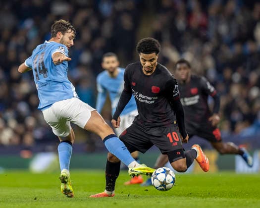 25th November 2025; Etihad Stadium, Manchester, England; UEFA Champions League Football, Manchester City versus Bayer Leverkusen; Malik Tillman of Bayer Leverkusen under pressure from Nico Gonzalez of Manchester City  TimxWilliams