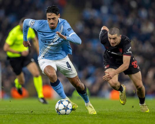 25th November 2025; Etihad Stadium, Manchester, England; UEFA Champions League Football, Manchester City versus Bayer Leverkusen; Tijjani Reijnders of Manchester City under pressure from Ibrahim Maza of Bayer Leverkusen  TimxWilliams
