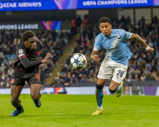 25th November 2025; Etihad Stadium, Manchester, England; UEFA Champions League Football, Manchester City versus Bayer Leverkusen; Savio of Manchester City under pressure from Ernest Poku of Bayer Leverkusen  TimxWilliams