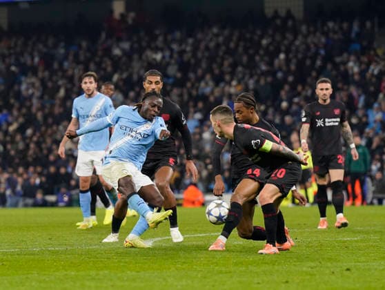 Manchester, England, 25th November 2025. Jeremy Doku of Manchester City has a shot blocked during the Manchester City vs Bayer Leverkusen UEFA Champions League match at the Etihad Stadium, Manchester. Picture credit should read: Andrew Yates Sportimage EDITORIAL USE ONLY. No use with unauthorised audio, video, data, fixture lists, club league logos or live services. Online in-match use limited to 120 images, no video emulation. No use in betting, games or single club league player publications. SPI_069_AY_Man_City_Leverkusen SPI-4309-0099