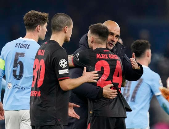 Manchester, England, 25th November 2025. Pep Guardiola coach of Manchester City congratulates Aleix Garcia of Bayer Leverkusen during the Manchester City vs Bayer Leverkusen UEFA Champions League match at the Etihad Stadium, Manchester. Picture credit should read: Andrew Yates Sportimage EDITORIAL USE ONLY. No use with unauthorised audio, video, data, fixture lists, club league logos or live services. Online in-match use limited to 120 images, no video emulation. No use in betting, games or single club league player publications. SPI_074_AY_Man_City_Leverkusen SPI-4309-0110