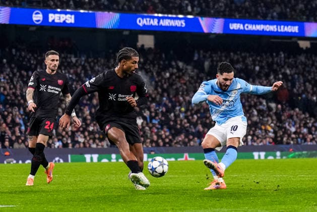 MANCHESTER, ENGLAND - NOVEMBER 25: Rayan Cherki of Manchester City shoots under pressure from Loic Bade of Bayer 04 Leverkusen during the UEFA Champions League 2025 26 League Phase MD5 match between Manchester City and Bayer 04 Leverkusen at City of Manchester Stadium on November 25, 2025 in Manchester, England. (Photo by Rene Nijhuis) SPO  Copyright: xRenexNijhuis