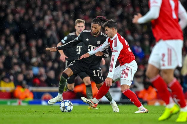 Michael Olise Bayern Muenchen and Martin Zubimendi Arsenal FC battle for the ball during the UEFA Champions League 2025 26 League Phase MD5 match between Arsenal FC and FC Bayern München at Arsenal Stadium on November 26, 2025 in London, United Kingdom Photo by Harry Langer DeFodi Images
