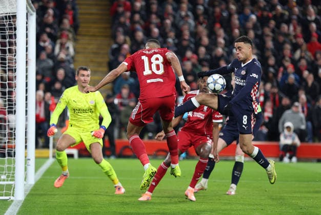 Liverpool, England, 26th November 2025. Cody Gakpo of Liverpool and Sergino Dest of PSV Eindhoven challenge for the ball with Liverpool claiming for a penalty for handball during the Liverpool vs PSV Eindhoven UEFA Champions League match at Anfield, Liverpool. Picture credit should read: James Baylis Sportimage EDITORIAL USE ONLY. No use with unauthorised audio, video, data, fixture lists, club league logos or live services. Online in-match use limited to 120 images, no video emulation. No use in betting, games or single club league player publications. SPI_060_JB_Liverpool_PSV SPI-4311-0060