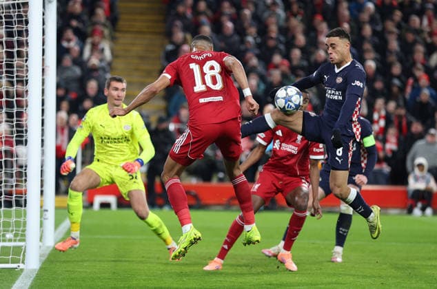 Liverpool, England, 26th November 2025. Cody Gakpo of Liverpool and Sergino Dest of PSV Eindhoven challenge for the ball with Liverpool claiming for a penalty for handball during the Liverpool vs PSV Eindhoven UEFA Champions League match at Anfield, Liverpool. Picture credit should read: James Baylis Sportimage EDITORIAL USE ONLY. No use with unauthorised audio, video, data, fixture lists, club league logos or live services. Online in-match use limited to 120 images, no video emulation. No use in betting, games or single club league player publications. SPI_061_JB_Liverpool_PSV SPI-4311-0061