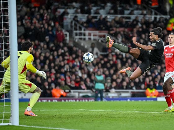 Goalkeeper David Raya Arsenal FC and Serge Gnabry Bayern Muenchen battle for the ball during the UEFA Champions League 2025 26 League Phase MD5 match between Arsenal FC and FC Bayern München at Arsenal Stadium on November 26, 2025 in London, United Kingdom Photo by Harry Langer DeFodi Images