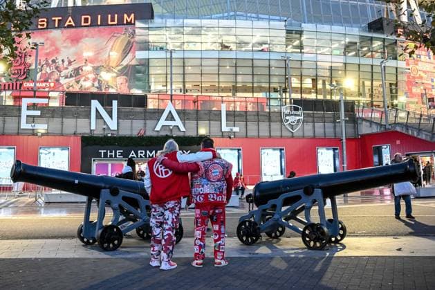 Two Bayern Munich fans arm in arm in front of the stadium during the UEFA Champions League 2025 26 League Phase MD5 match between Arsenal FC and FC Bayern München at Arsenal Stadium on November 26, 2025 in London, United Kingdom Photo by Harry Langer DeFodi Images