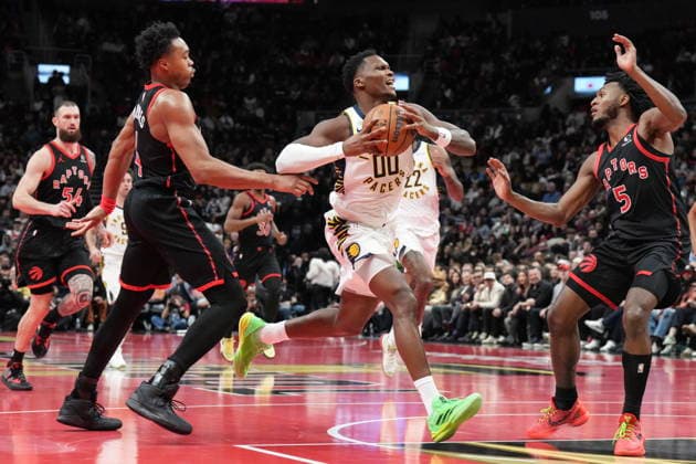 November 26, 2025, Toronto, On, CAN: Indiana Pacers guard Bennedict Mathurin (00) drives between Toronto Raptors forward Scottie Barnes (4) and guard Immanuel Quickley (5) during second half NBA, Basketball Herren, USA Cup basketball action in Toronto on Wednesday, November 26, 2025. Bennedict Mathurin; Scottie Barnes; Immanuel Quickley  - ZUMAc35_ 20251126_zaf_c35_198 Copyright: xChrisxYoungx