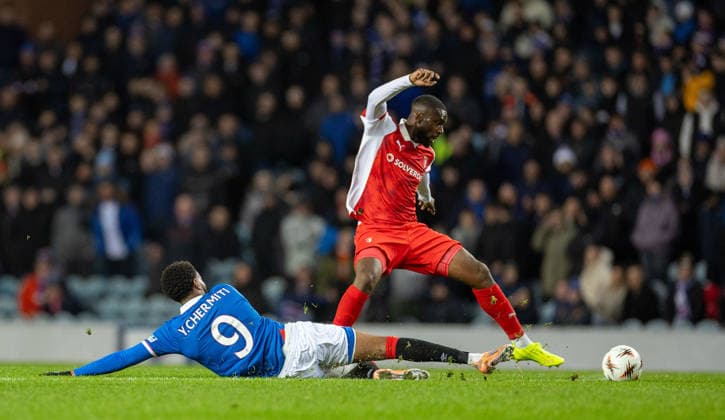 27th November 2025; Ibrox Stadium, Glasgow, Scotland; UEFA Europa League Football, Rangers versus Braga; Youssef Chermiti of Rangers slide tackles Sikou Niakate of SC Braga  VagelisxGeorgariou
