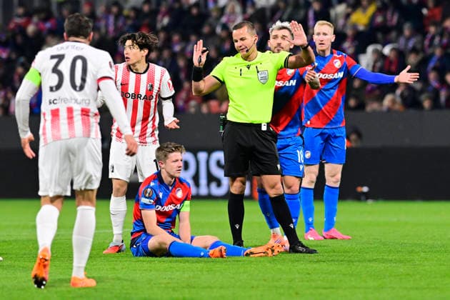 Lukas Cerv from Plzen sitting on the grass after being fouled and referee Morten Krogh during the Football Europa League, 5th round match: FC Viktoria Plzen vs SC Freiburg in Pilsen, Czech Republic, November 27, 2025. (CTKxPhoto MiroslavxChaloupka) CTKPhotoP2025112708196  CTKPhotoP2025112708196
