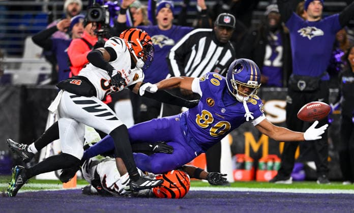 Baltimore Ravens tight end Isaiah Likely (80) bobbles a 44-yard touchdown pass to the end zone under pressure from Cincinnati Bengals cornerback Jalen Davis (35) that was reviewed and ruled a fumble and a touchback during the second quarter at M&T Bank Stadium in Baltimore, Maryland, on Thursday, November 27 2025.  BAL20251127116 DAVIDxTULIS