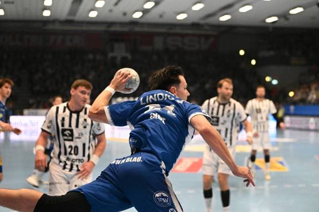 Moritz Ende 21 ThSV Eisenach throws on goal while Lukas Laube 20 THW Kiel defends Moritz Ende 21 ThSV Eisenach throw on goal Copyright: xspeedshotIPTCxTESTx