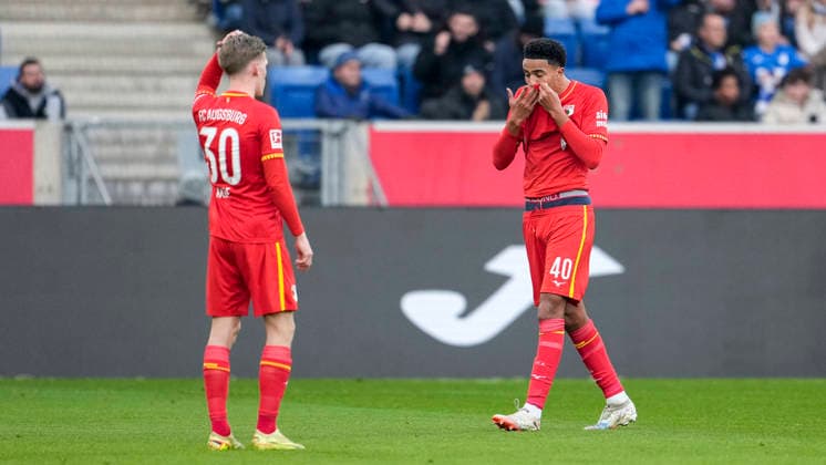 from left Anton Kade FCA, 30 , Noahkai Banks FCA, 40 , player of FC Augsburg, looking disappointed, disappointment, frustration, disappointed, pessimistic, after the conceded goal to 1 0, action, action, game scene, 29 11 2025, Sinsheim Germany , Soccer, Bundesliga, TSG 1899 Hoffenheim FC Augsburg, DFB DFL REGULATIONS PROHIBIT ANY USE OF PHOTOGRAPHS AS IMAGE SEQUENCES AND OR QUASI VIDEO xozx