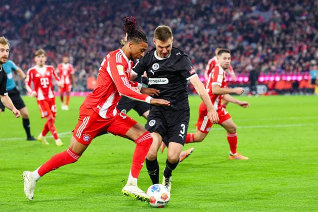 Michael Olise 17, FC Bayern Munich and Karol Mets 3, FC St Pauli at the match between FC Bayern Munich v FC St Pauli, Football, Men, Bundesliga, 2025 2026, Matchday 12 on 29 11 2025 in Munich, Allianz Arena DFL and DFB regulations prohibit any use of photographs as image sequences and or quasi video Bayern Germany