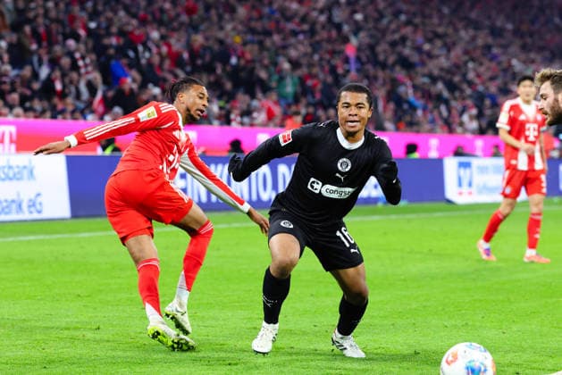Joel Chima Fujita 16, FC St Pauli and Michael Olise 17, FC Bayern München at the match between FC Bayern München v FC St Pauli, Football, Men, Bundesliga, 2025 2026, Matchday 12 on 29 11 2025 in Munich, Allianz Arena DFL and DFB regulations prohibit any use of photographs as image sequences and or quasi video Bayern Germany